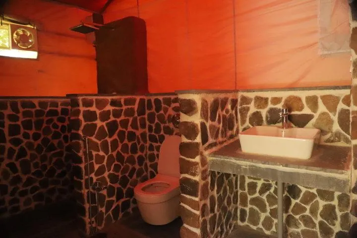 Stone-walled bathroom inside a tent