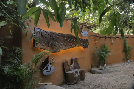 Mud-plastered entrance wall with a carved wooden Yaarnagar sign